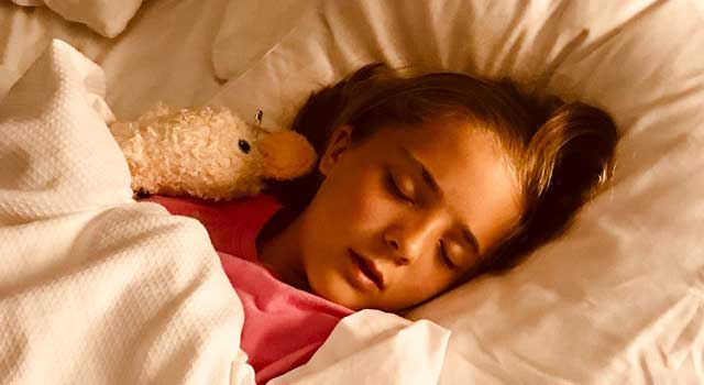 girl sleeping on bed 1359554